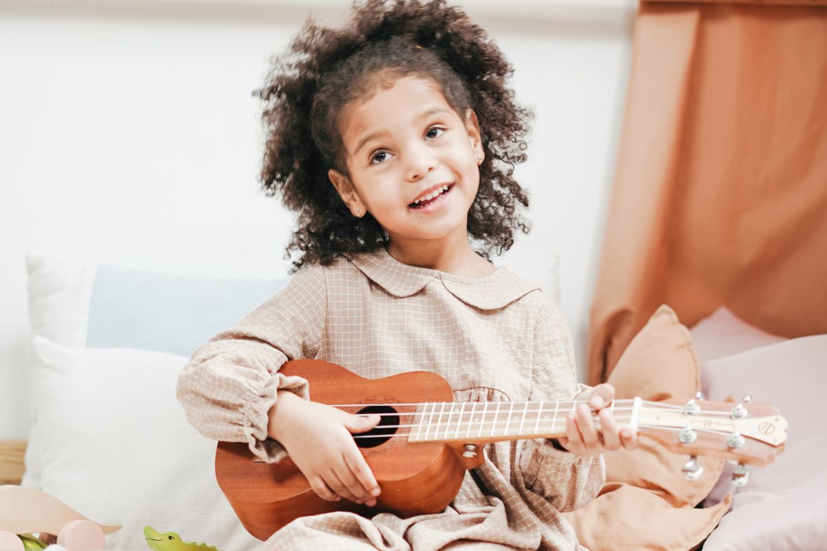 https://www.pexels.com/photo/photo-of-a-girl-playing-ukulele-3662762/
