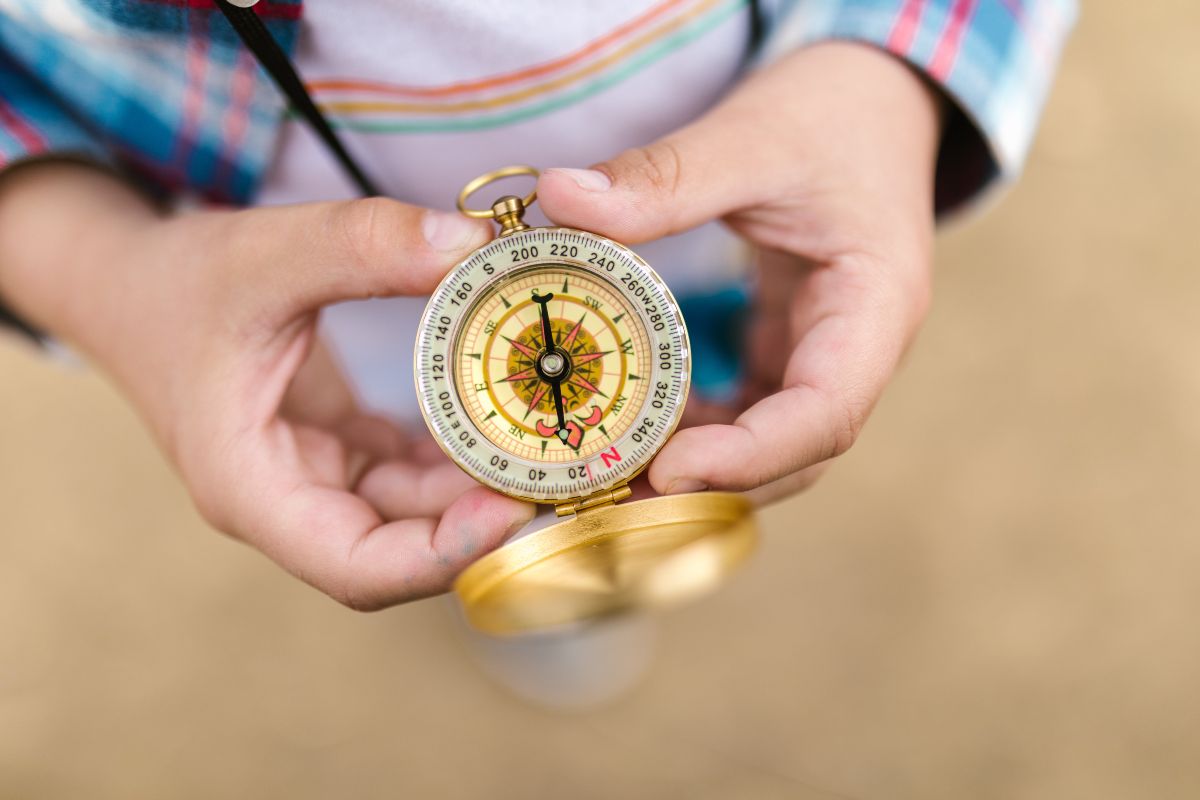 https://www.pexels.com/photo/gold-and-silver-compass-on-person-s-hand-8082893/