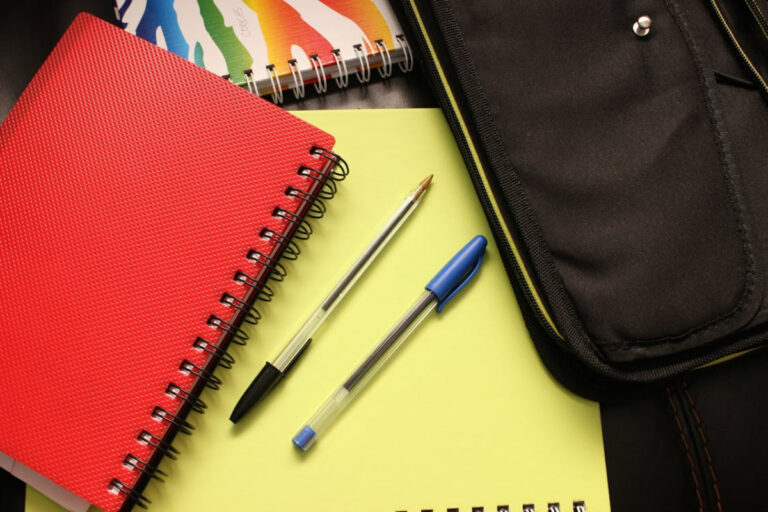 https://www.pexels.com/photo/black-and-blue-pens-beside-red-covered-notebook-159497/